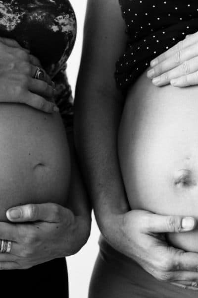 two pregnant women black and white
