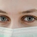 woman with surgical mask over face